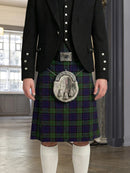 Person wearing a traditional Scottish kilt with a jacket indoors.