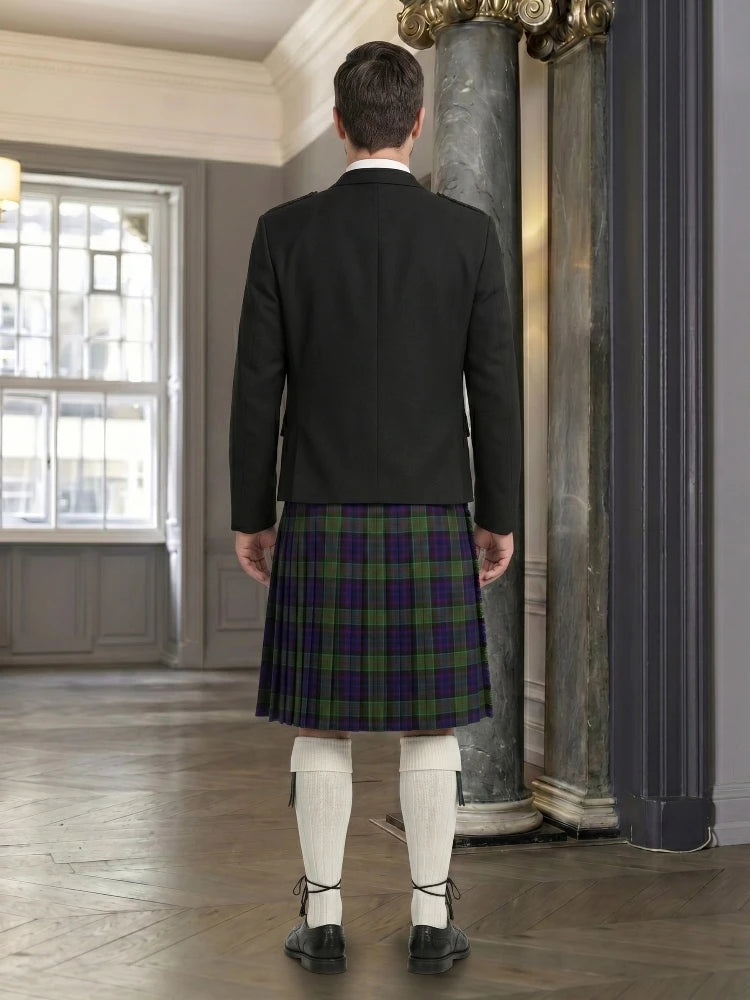 Man wearing a dark jacket and plaid kilt in an indoor setting.