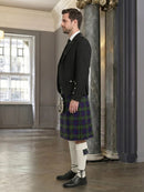 Man wearing a traditional Scottish kilt in an elegant interior setting