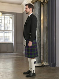 Man wearing a traditional Scottish kilt in an elegant interior setting