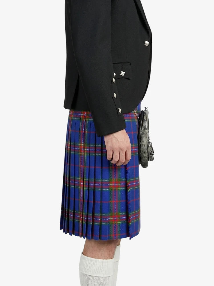 Person wearing a black jacket and blue plaid kilt on a white background