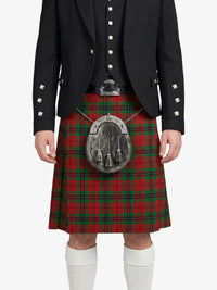 Person wearing a red tartan kilt with a black jacket on a white background