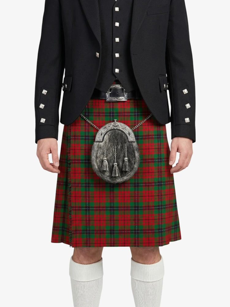 Person wearing a red tartan kilt with a black jacket on a white background