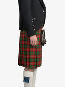 Person wearing a red plaid kilt with a black jacket on a white background