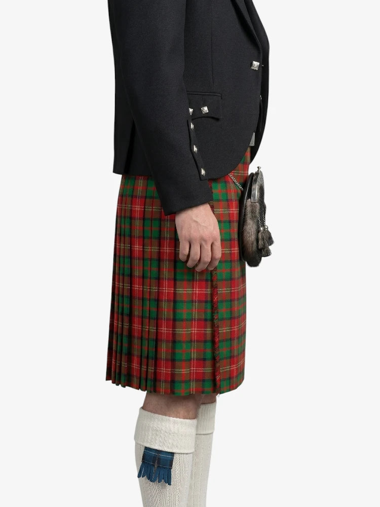 Person wearing a red plaid kilt with a black jacket on a white background