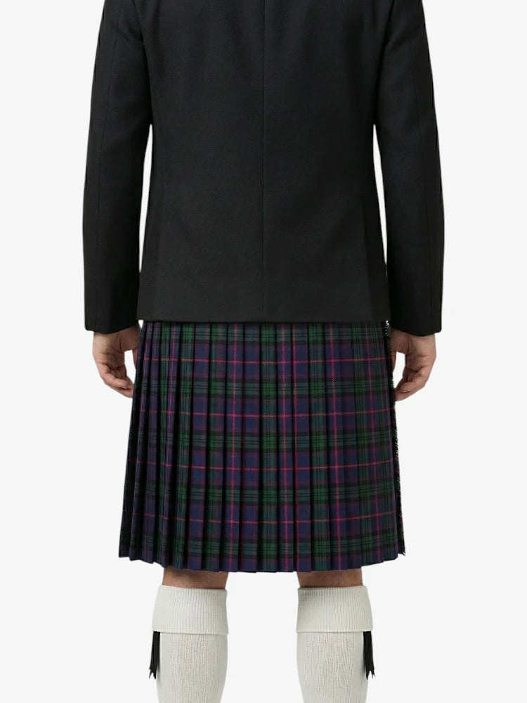 Person wearing a black coat and plaid kilt on a white background