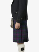 Person wearing a black jacket and tartan kilt on a white background