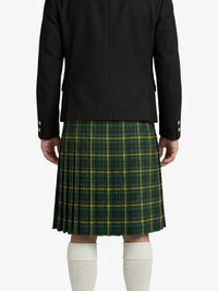 Person wearing a black jacket and green plaid kilt on a white background