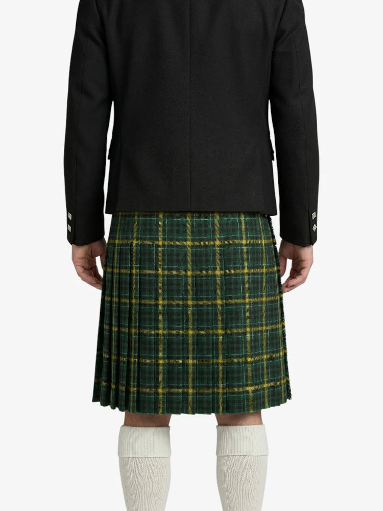 Person wearing a black jacket and green plaid kilt on a white background