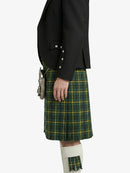Person wearing a black jacket and green plaid kilt on a white background