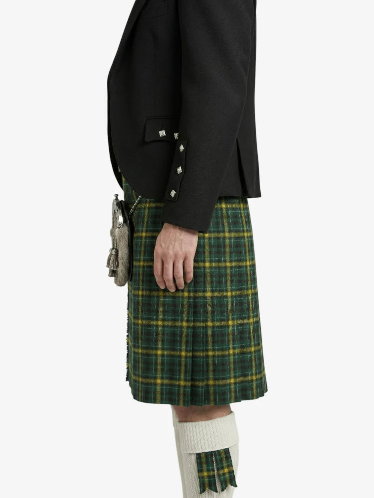Person wearing a black jacket and green plaid kilt on a white background