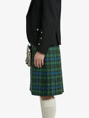Person wearing a black jacket and green plaid kilt on a white background