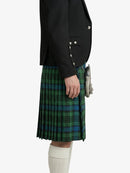 Person wearing a black jacket and green plaid kilt on a white background