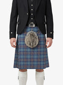 Person wearing a traditional Scottish kilt with a tartan pattern on a white background