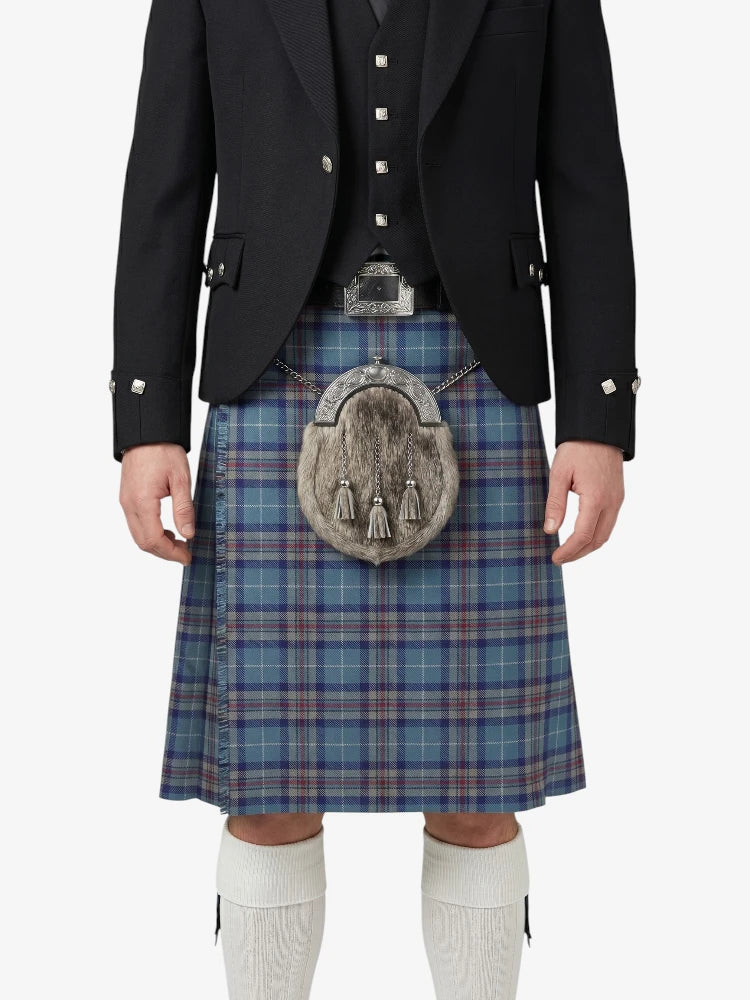 Person wearing a traditional Scottish kilt with a tartan pattern on a white background
