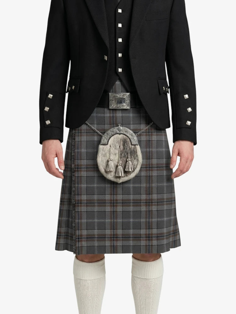 Person wearing a black jacket, gray plaid kilt, and white knee-high socks on a white background