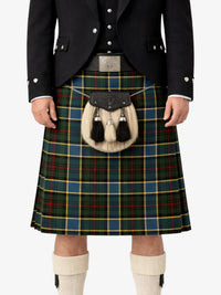 Person wearing a traditional Scottish kilt with a tartan pattern on a white background
