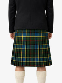 Person wearing a black jacket and green plaid kilt on a white background