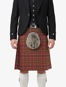 Person wearing a traditional Scottish kilt with a jacket on a white background