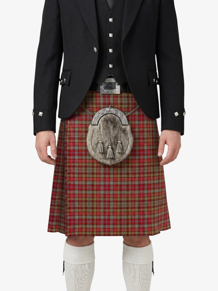 Person wearing a traditional Scottish kilt with a jacket on a white background