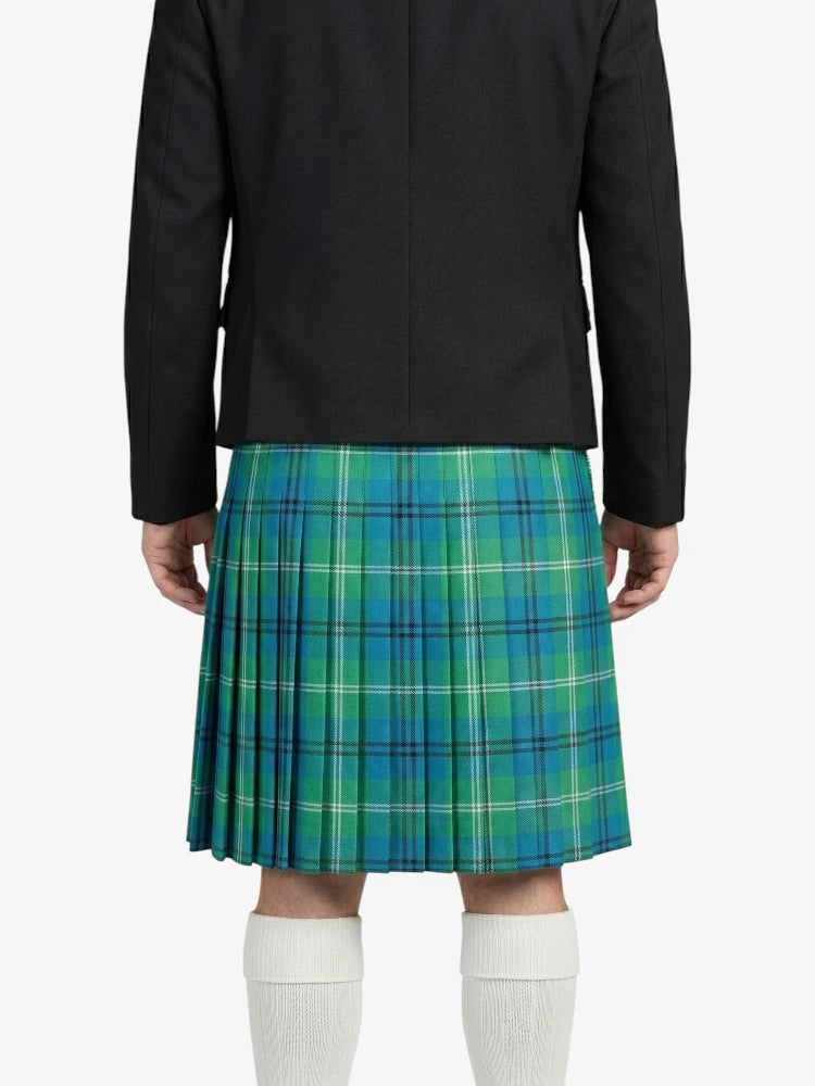 Person wearing a black jacket and blue plaid kilt on a white background