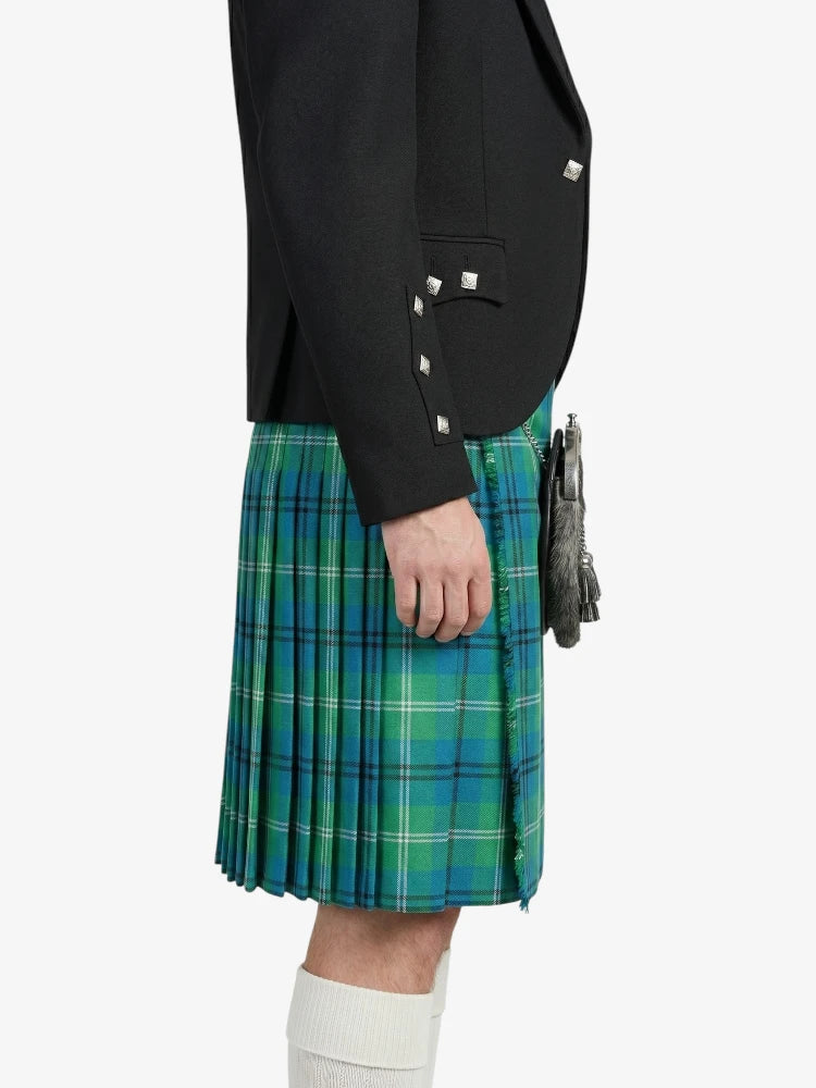Person wearing a black jacket and green plaid kilt on a white background