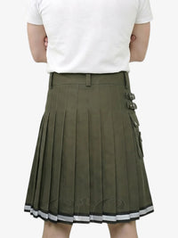 Person wearing a green pleated skirt with a white background