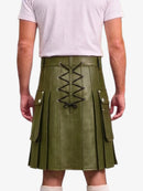 An olive green faux-leather kilt with a central lace-up closure and side flap pockets, shown on a model from the back wearing a light pink t-shirt.
