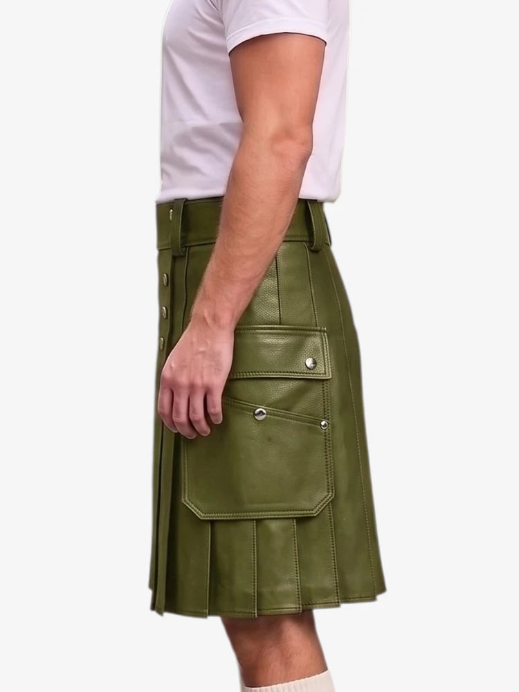 A side view of a person wearing an olive green faux-leather kilt with silver snap button details and pleated folds, paired with a white t-shirt against a light gray background.