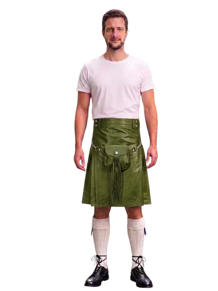 A man modeling a green faux-leather kilt with a front pouch and silver buckle, paired with a white t-shirt, cream knee-high socks, and black lace-up shoes, against a plain white background.