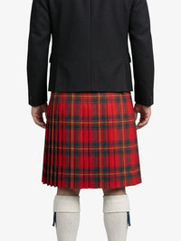 Person wearing a red plaid kilt with a black jacket on a white background