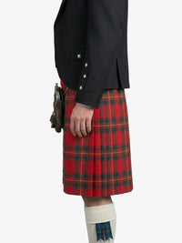 Person wearing a black jacket and red plaid kilt on a white background