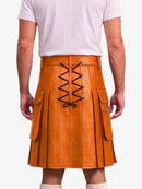 A man wearing a tan leather kilt with a lace-up back closure, shown from the back against a light gray studio background.