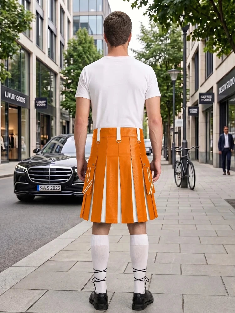 A man stands on a city sidewalk facing away from the camera, wearing a bright orange pleated kilt with white vertical stripes, a white t-shirt, white knee-high socks, and black shoes. Buildings, trees, a black Mercedes, and a bicycle are visible in the urban street setting.