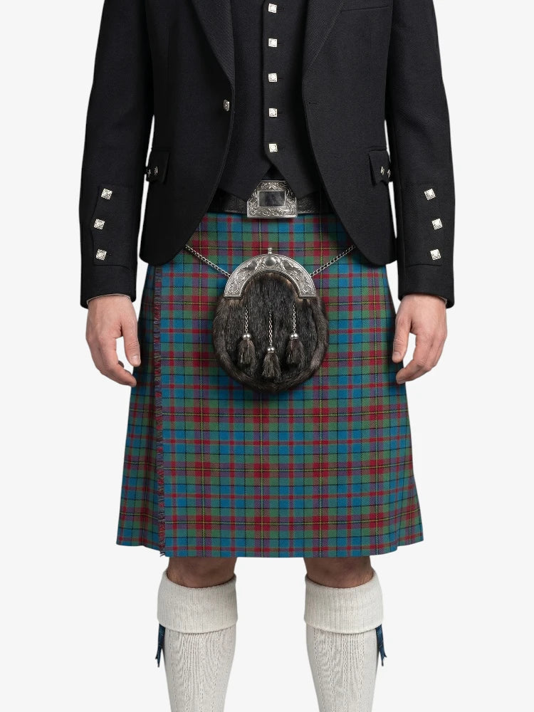 Person wearing a traditional Scottish kilt with a sporran on a white background