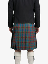 Person wearing a black jacket and a plaid kilt on a white background