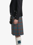 Person wearing a black jacket and plaid kilt on a white background