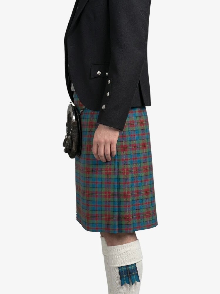 Person wearing a black jacket and plaid kilt on a white background
