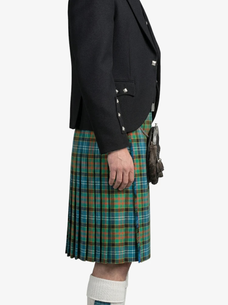 Person wearing a black blazer and green plaid kilt on a white background
