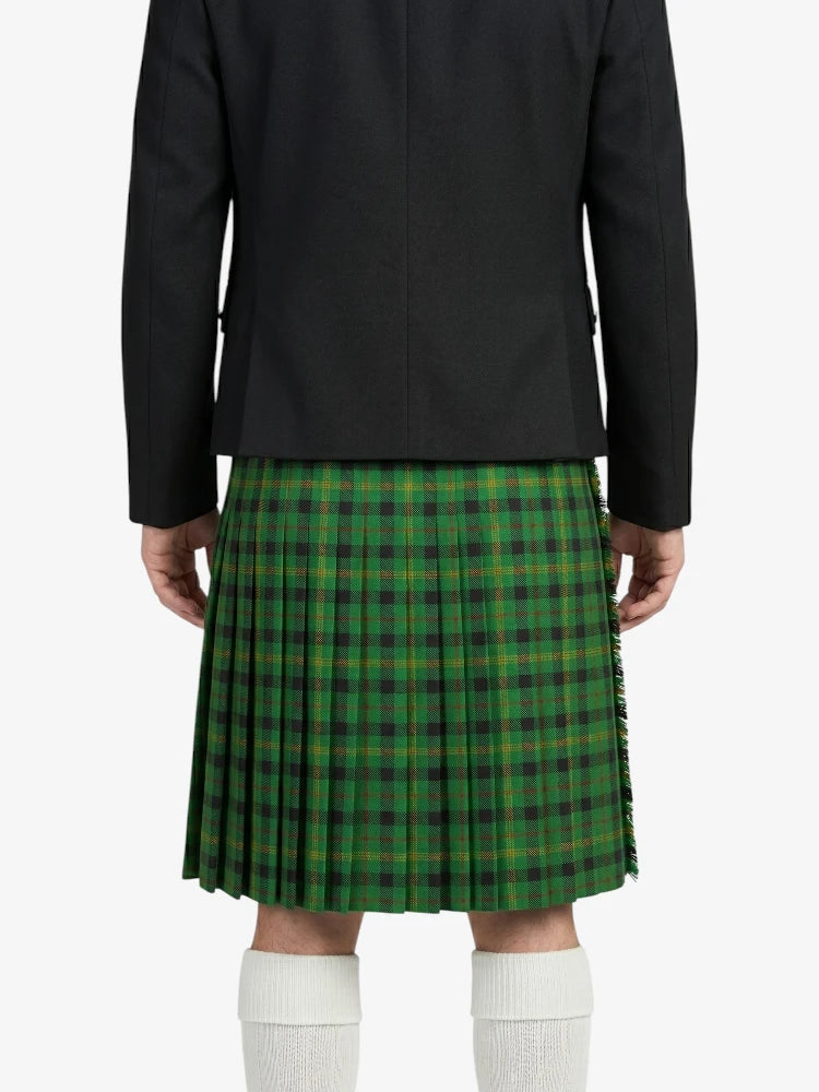 Person wearing a green plaid kilt with a black jacket on a white background