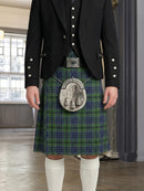 Person wearing a traditional Scottish kilt with a jacket indoors.