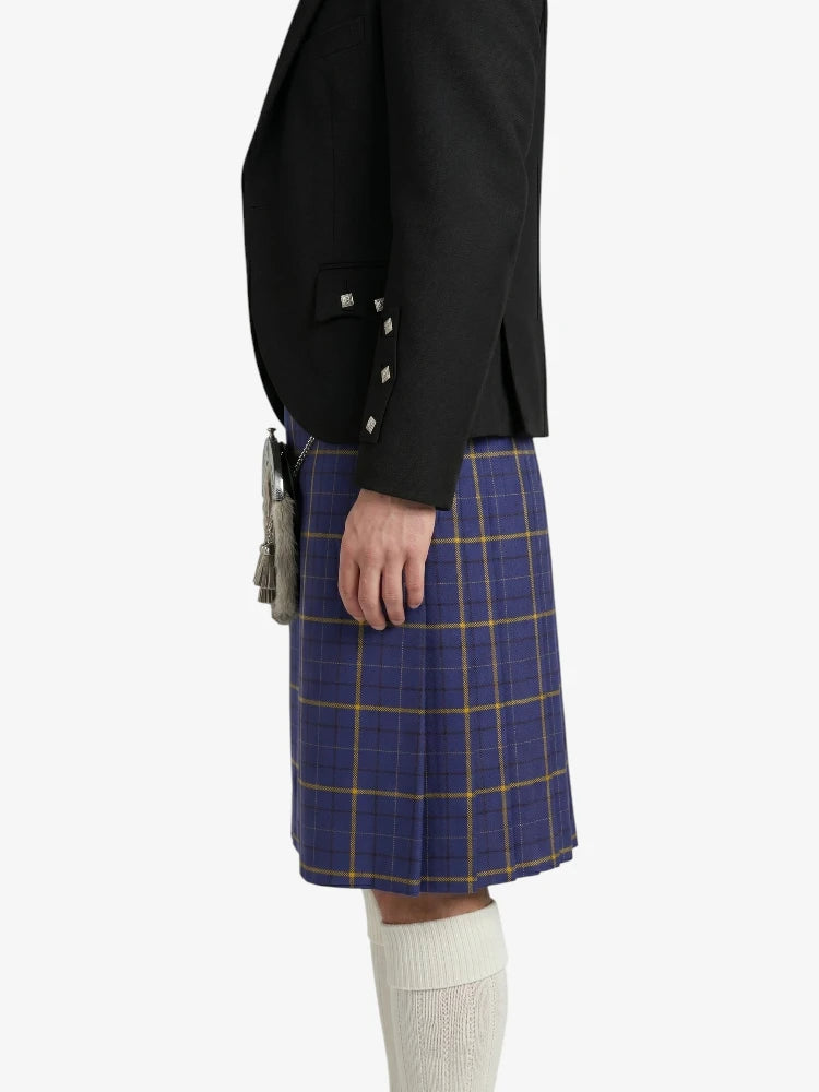 Person wearing a black jacket and blue plaid kilt on a white background