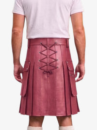 A person shown from the back wearing a pleated kilt in dusty rose pink faux leather with a lace-up back closure and side cargo pockets, paired with a light pink t-shirt and white socks against a light gray background.