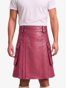 A person wearing a dusty rose faux leather kilt with silver-tone metal buttons and side flap pockets, paired with a white t-shirt against a light gray background.