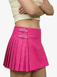 Pink pleated skirt with a buckle on a white background