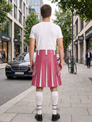A man viewed from behind wearing a pink pleated leather kilt with white vertical stripe details, a white t-shirt, white knee-high socks, and black shoes, standing on a city sidewalk.