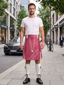 A man standing on a city sidewalk wearing a white t-shirt, a pink kilt with white geometric patterns, white knee-high socks, and black leather shoes. A black Mercedes-Benz car and a bicycle are visible in the background of the street scene.