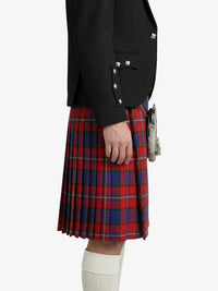 Person wearing a black jacket and red plaid kilt on a white background