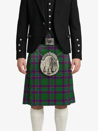 Person wearing a green plaid kilt with a black jacket on a white background