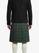 Person wearing a black jacket and green plaid kilt on a white background